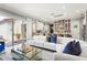 Bright living room showcasing an open floor plan with a modern kitchen and access to the outdoor patio at 10067 Mere Pkwy, Orlando, FL 32832