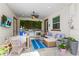 Outdoor living space with a dining area, TV, and built-in grill at 10067 Mere Pkwy, Orlando, FL 32832
