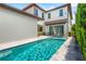 Sparkling pool with travertine tile decking creates a backyard oasis with an attached covered patio at 10067 Mere Pkwy, Orlando, FL 32832