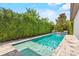 Backyard swimming pool with lush greenery and a waterfall feature at 10067 Mere Pkwy, Orlando, FL 32832