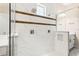 Modern shower with dual shower heads, stylish tile work, and glass enclosure, part of a luxurious bathroom at 10067 Mere Pkwy, Orlando, FL 32832