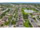 Residential community aerial view showing mature trees, a pond, and many single Gathering homes at 12606 Old Plantation Ln, Orlando, FL 32824
