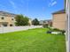 Spacious backyard features a white fence enclosing manicured green lawn and landscaping at 12606 Old Plantation Ln, Orlando, FL 32824