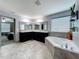 Relaxing primary bathroom featuring a soaking tub and dual vanity sinks at 12606 Old Plantation Ln, Orlando, FL 32824