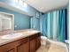Charming bathroom featuring a dual vanity, toilet, and shower with curtain at 12606 Old Plantation Ln, Orlando, FL 32824