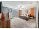 Comfortable bedroom with soft carpet, large window, ceiling fan, and a neutral color palette at 12606 Old Plantation Ln, Orlando, FL 32824