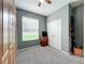 Carpeted bedroom with a closet, storage cabinet and a mounted guitar rack at 12606 Old Plantation Ln, Orlando, FL 32824
