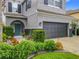 Well-maintained two story home featuring a large garage, manicured landscaping, and a blue front door at 12606 Old Plantation Ln, Orlando, FL 32824