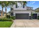 Charming home featuring a spacious garage and well-manicured lawn with flowering plants at 12606 Old Plantation Ln, Orlando, FL 32824
