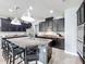 Modern kitchen with a large island, dark wood cabinetry, granite countertops, and bar seating at 12606 Old Plantation Ln, Orlando, FL 32824