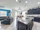 Open concept kitchen with a spacious island, stainless steel appliances, and pendant lighting at 12606 Old Plantation Ln, Orlando, FL 32824