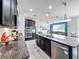 Stylish kitchen with dark cabinetry, granite countertops, and stainless steel appliances at 12606 Old Plantation Ln, Orlando, FL 32824