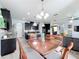 Open concept living room and kitchen with pendant lighting and granite countertops, perfect for entertaining at 12606 Old Plantation Ln, Orlando, FL 32824