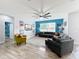 Spacious living room features modern decor, a ceiling fan, and a large sectional sofa at 12606 Old Plantation Ln, Orlando, FL 32824