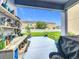 Covered patio featuring a plant display with view of the backyard and neighboring home at 12606 Old Plantation Ln, Orlando, FL 32824
