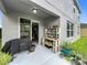 Covered patio with BBQ, exterior storage, and sliding glass door access to dining area at 12606 Old Plantation Ln, Orlando, FL 32824