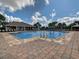 Community pool featuring brick pavers, a fountain, lounge chairs, and a clubhouse at 12606 Old Plantation Ln, Orlando, FL 32824