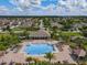 Aerial view of the community pool, lined with lounging chairs and lush landscaping at 12606 Old Plantation Ln, Orlando, FL 32824