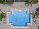 Aerial view of the community pool showcasing ample lounge chairs, surrounding brick pavers, and a few swimmers at 12606 Old Plantation Ln, Orlando, FL 32824