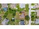 Aerial view of property showcasing landscaping, a pool, and surrounding neighborhood layout at 138 Hidden Pointe Ln, Groveland, FL 34736