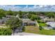 Aerial view of a well-maintained home showing the roof, landscaping, and surrounding neighborhood at 138 Hidden Pointe Ln, Groveland, FL 34736