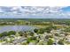 Wide aerial shot showcases community and large lake, highlighting the beautiful landscape with lush greenery at 138 Hidden Pointe Ln, Groveland, FL 34736