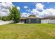 Backyard of home with manicured lawn and white fence at 138 Hidden Pointe Ln, Groveland, FL 34736