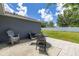 Backyard patio with patio set and a white fence at 138 Hidden Pointe Ln, Groveland, FL 34736