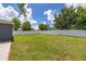 View of backyard with a well kept lawn and a white fence at 138 Hidden Pointe Ln, Groveland, FL 34736