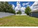 Backyard of home with large yard and white fence at 138 Hidden Pointe Ln, Groveland, FL 34736