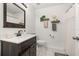 Bathroom features updated dark wood vanity, white countertop, and neutral decor accents at 138 Hidden Pointe Ln, Groveland, FL 34736