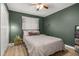Cozy bedroom featuring warm green walls, double closet, and warm natural lighting at 138 Hidden Pointe Ln, Groveland, FL 34736