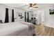 Bedroom featuring a ceiling fan, wood-look flooring, and an ensuite bathroom at 138 Hidden Pointe Ln, Groveland, FL 34736