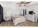 Bedroom featuring a ceiling fan, wood-look flooring, and ample natural light at 138 Hidden Pointe Ln, Groveland, FL 34736