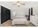 Bedroom featuring a ceiling fan, wood-look flooring, and ample natural light at 138 Hidden Pointe Ln, Groveland, FL 34736