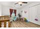 Bright bedroom featuring a ceiling fan, wood-look flooring, and closet for ample storage space at 138 Hidden Pointe Ln, Groveland, FL 34736