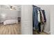 Bedroom featuring a ceiling fan, wood-look flooring, and a view of a walk-in closet at 138 Hidden Pointe Ln, Groveland, FL 34736