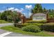 Community entrance sign for Hidden Lakes Estates featuring brick pillars, manicured landscaping, and clear signage at 138 Hidden Pointe Ln, Groveland, FL 34736