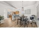 Cozy dining room featuring modern table and chairs, pendant lighting, and bar access to the kitchen at 138 Hidden Pointe Ln, Groveland, FL 34736