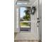 View of an open front door and sunlit walkway with views to the outside at 138 Hidden Pointe Ln, Groveland, FL 34736