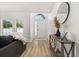 Entryway featuring a modern console table and decor with an open doorway to a sunlit front yard at 138 Hidden Pointe Ln, Groveland, FL 34736