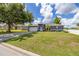 Beautifully landscaped front yard with well-maintained grass leading up to the home's inviting entrance at 138 Hidden Pointe Ln, Groveland, FL 34736