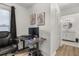 Home office with a modern desk setup and view to the ensuite bathroom with marble counter at 138 Hidden Pointe Ln, Groveland, FL 34736