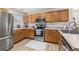 Modern kitchen featuring wood cabinets, stainless steel appliances, and updated countertops at 138 Hidden Pointe Ln, Groveland, FL 34736