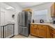 Kitchen featuring stainless steel fridge and wood cabinets with adjacent laundry room entrance at 138 Hidden Pointe Ln, Groveland, FL 34736