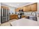 Modern kitchen featuring wood cabinets, stainless steel appliances, and updated countertops at 138 Hidden Pointe Ln, Groveland, FL 34736