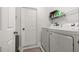 Clean laundry room featuring a new washer and dryer with additional storage space at 138 Hidden Pointe Ln, Groveland, FL 34736