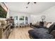 Bright living room features a ceiling fan, large windows, and a comfortable sectional sofa at 138 Hidden Pointe Ln, Groveland, FL 34736