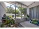 Enclosed patio with patio set, plant and ' table and chairs at 138 Hidden Pointe Ln, Groveland, FL 34736
