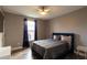 Bedroom featuring large window, hardwood floors, and modern decor at 14205 Falls Church Dr # 2012, Orlando, FL 32837